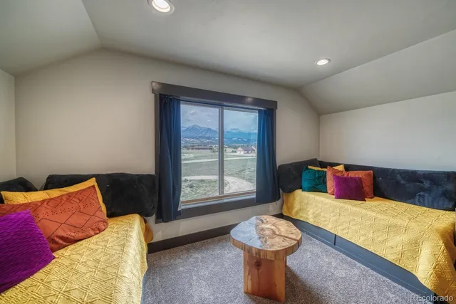 a living room with furniture a couch and a chandelier