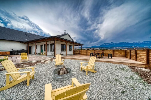 a view of balcony with furniture and a garden