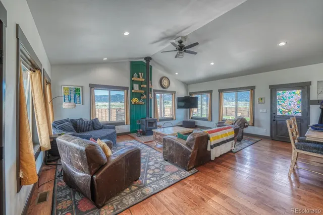 a living room with furniture flat screen tv and wooden floor