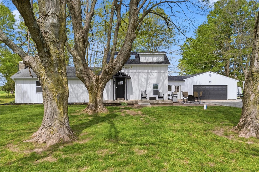 2950 Fairfield Pike Springfield, OH 45502 - Photo 2 of 48 This charming farmhouse offers a perfect blend of comfort and outdoor living, nestled amidst mature trees.