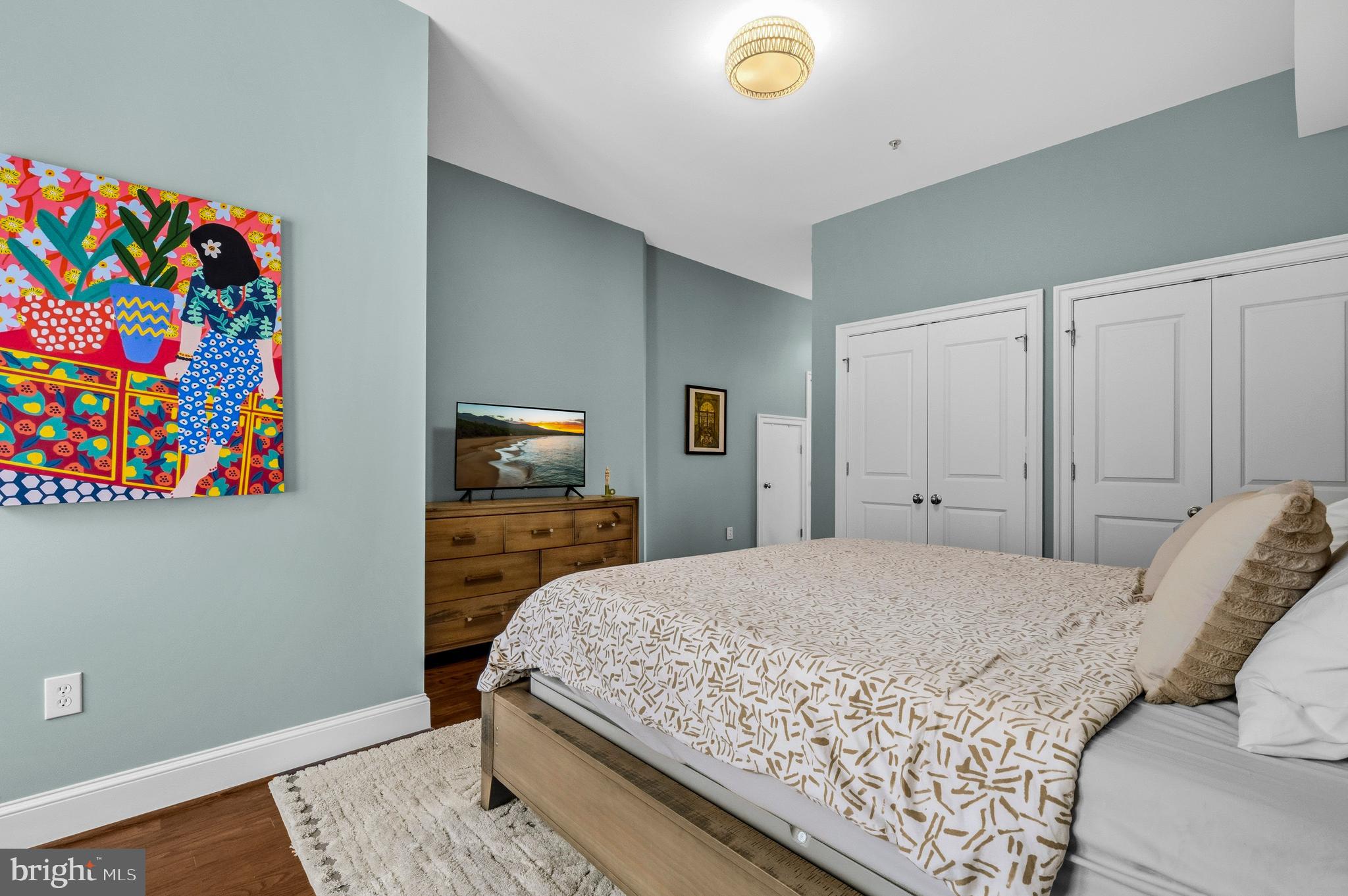 1232 4th Street Northwest, Unit 1 Washington, DC 20001 - Photo 17 of 28 a bedroom with a bed and a dresser
