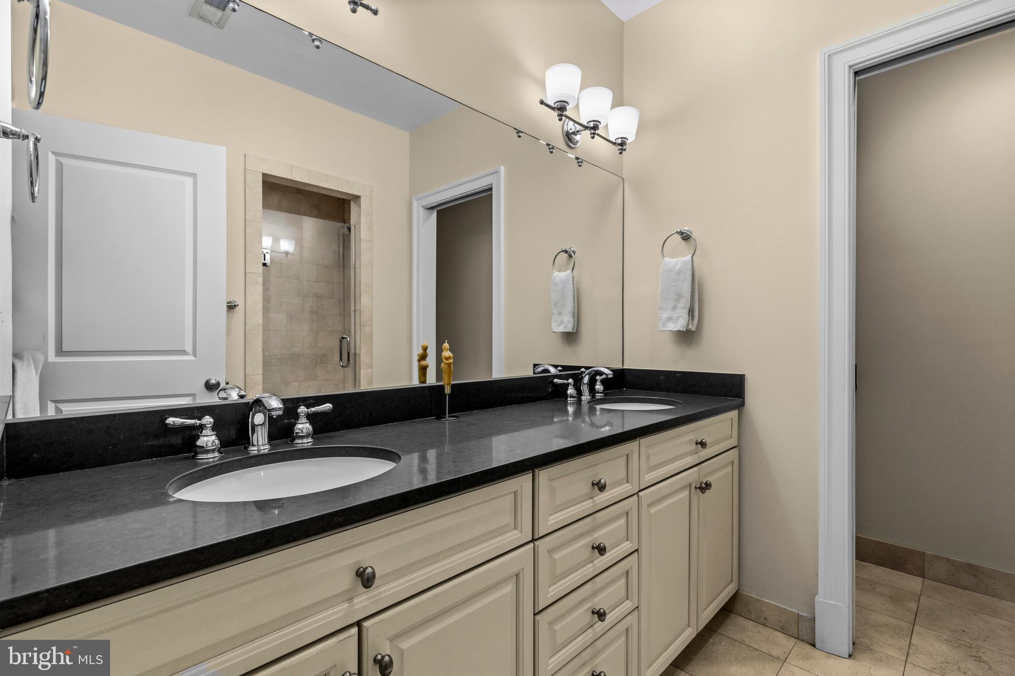 1232 4th Street Northwest, Unit 1 Washington, DC 20001 - Photo 19 of 28 a bathroom with double vanity sinks and a mirror