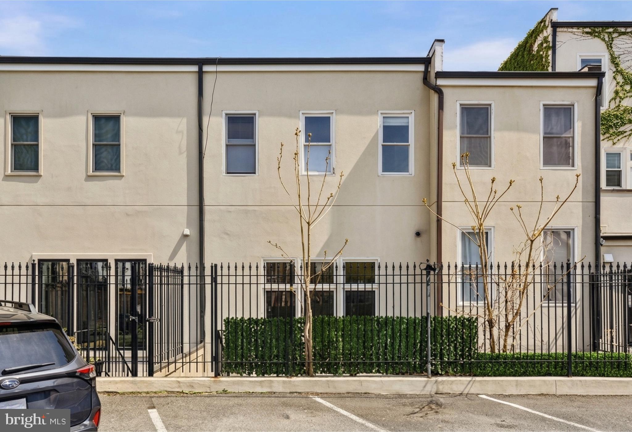 1232 4th Street Northwest, Unit 1 Washington, DC 20001 - Photo 25 of 28 a view of a brick house with many windows