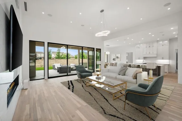 a large kitchen with stainless steel appliances kitchen island a large counter top and a wooden floors