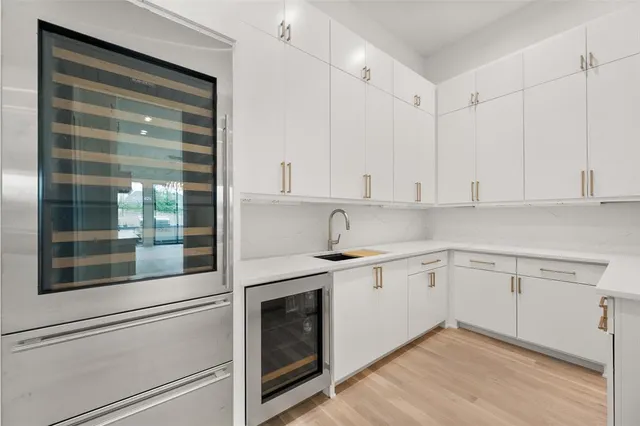 a kitchen with stainless steel appliances a microwave a stove and white cabinets