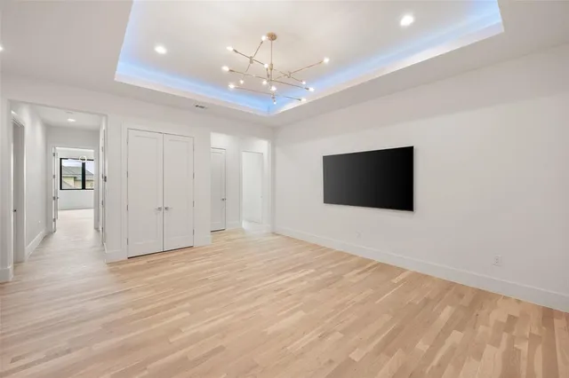a view of an empty room with kitchen and kitchen view