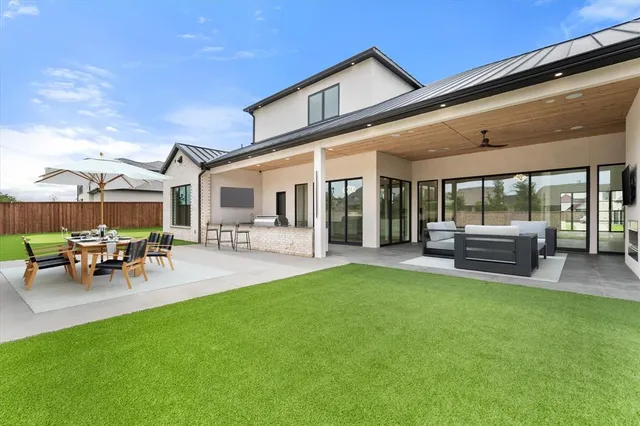 a view of a backyard with a patio and outdoor seating