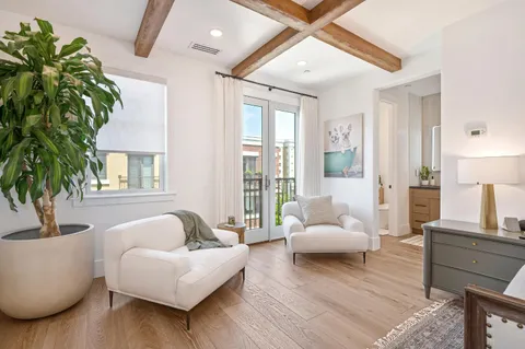 a living room with furniture and kitchen view
