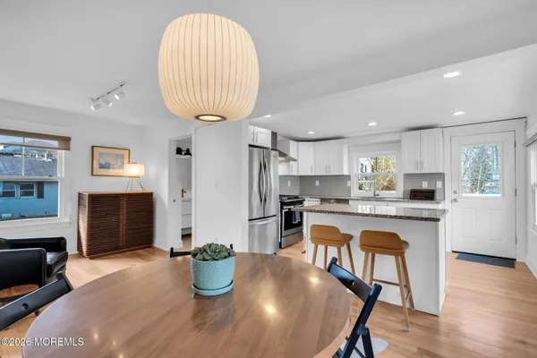 a kitchen with stainless steel appliances granite countertop a refrigerator sink and stove