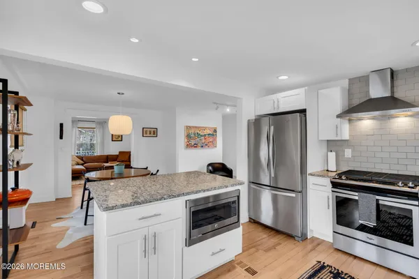 a kitchen with granite countertop a sink and a stove