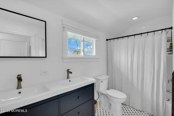a bedroom with a bed next to a window