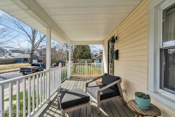 a balcony with chairs and outdoor view
