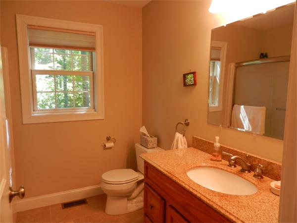 621 Burts Pit Road Northampton, MA 01062 - Photo 17 of 22 a bathroom with a granite countertop toilet a sink and a mirror