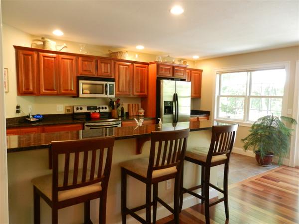 621 Burts Pit Road Northampton, MA 01062 - Photo 8 of 22 a kitchen with a table chairs microwave and cabinets