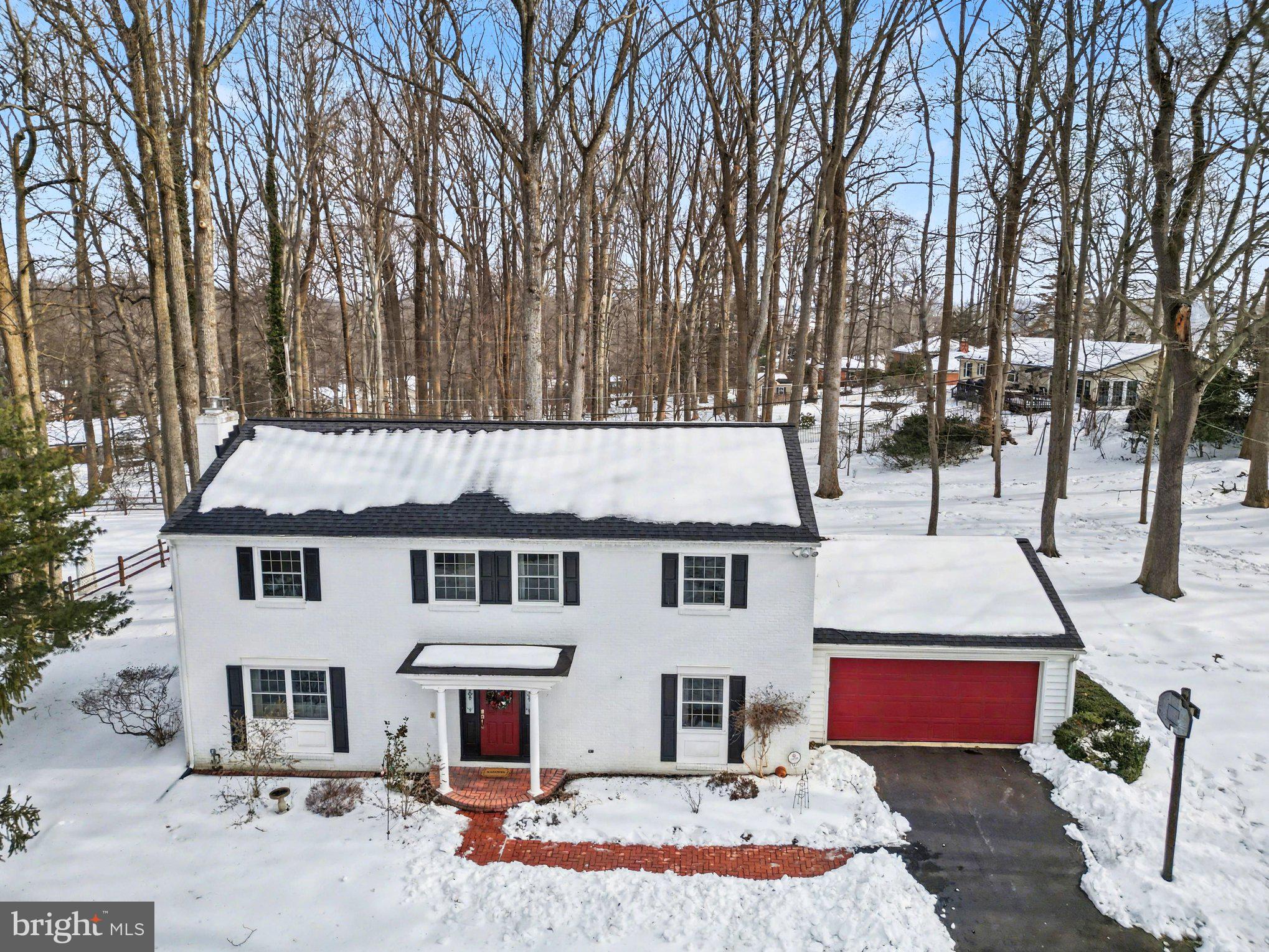 front view of house with large trees