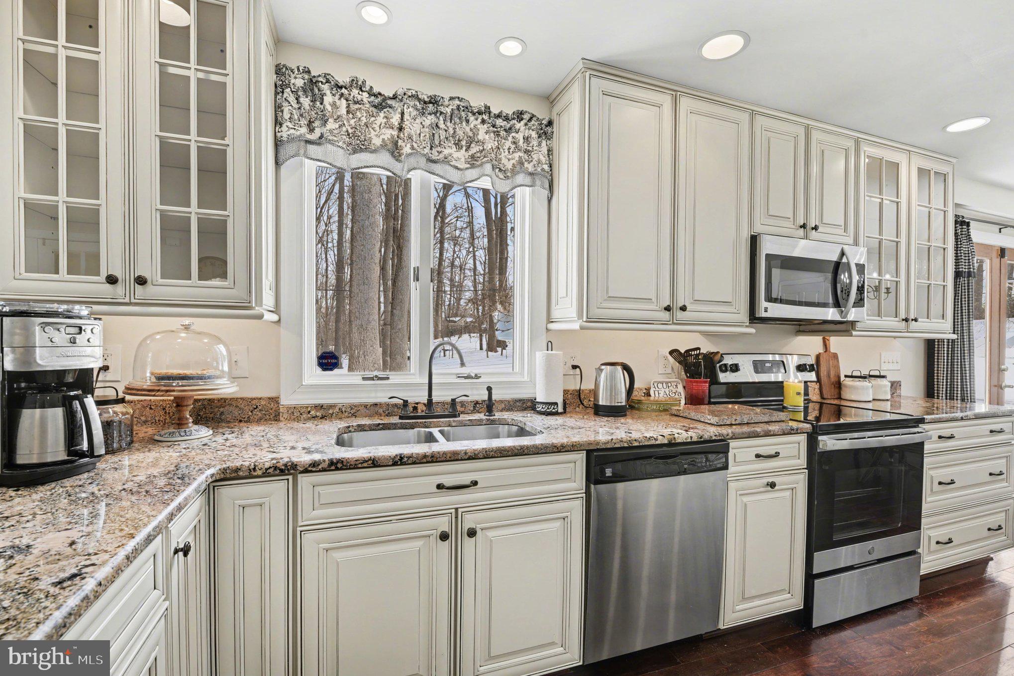 1411 Valley Stream Road Bel Air, MD 21014 - Photo 14 of 49 a kitchen with stainless steel appliances granite countertop a sink stove and cabinets