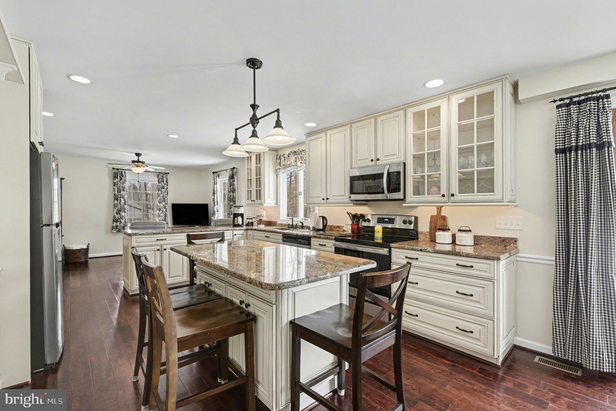 1411 Valley Stream Road Bel Air, MD 21014 - Photo 15 of 49 a kitchen with a table chairs microwave and refrigerator