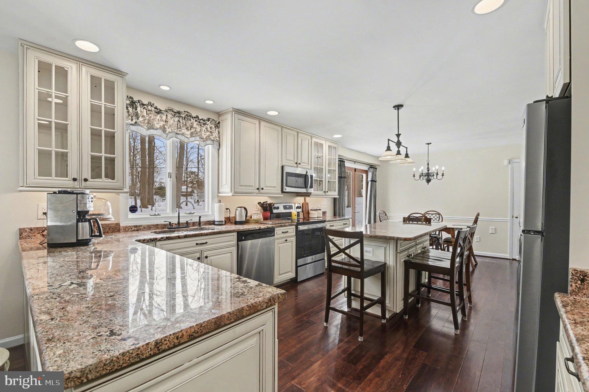 1411 Valley Stream Road Bel Air, MD 21014 - Photo 17 of 49 a kitchen with stainless steel appliances granite countertop table chairs sink and cabinets