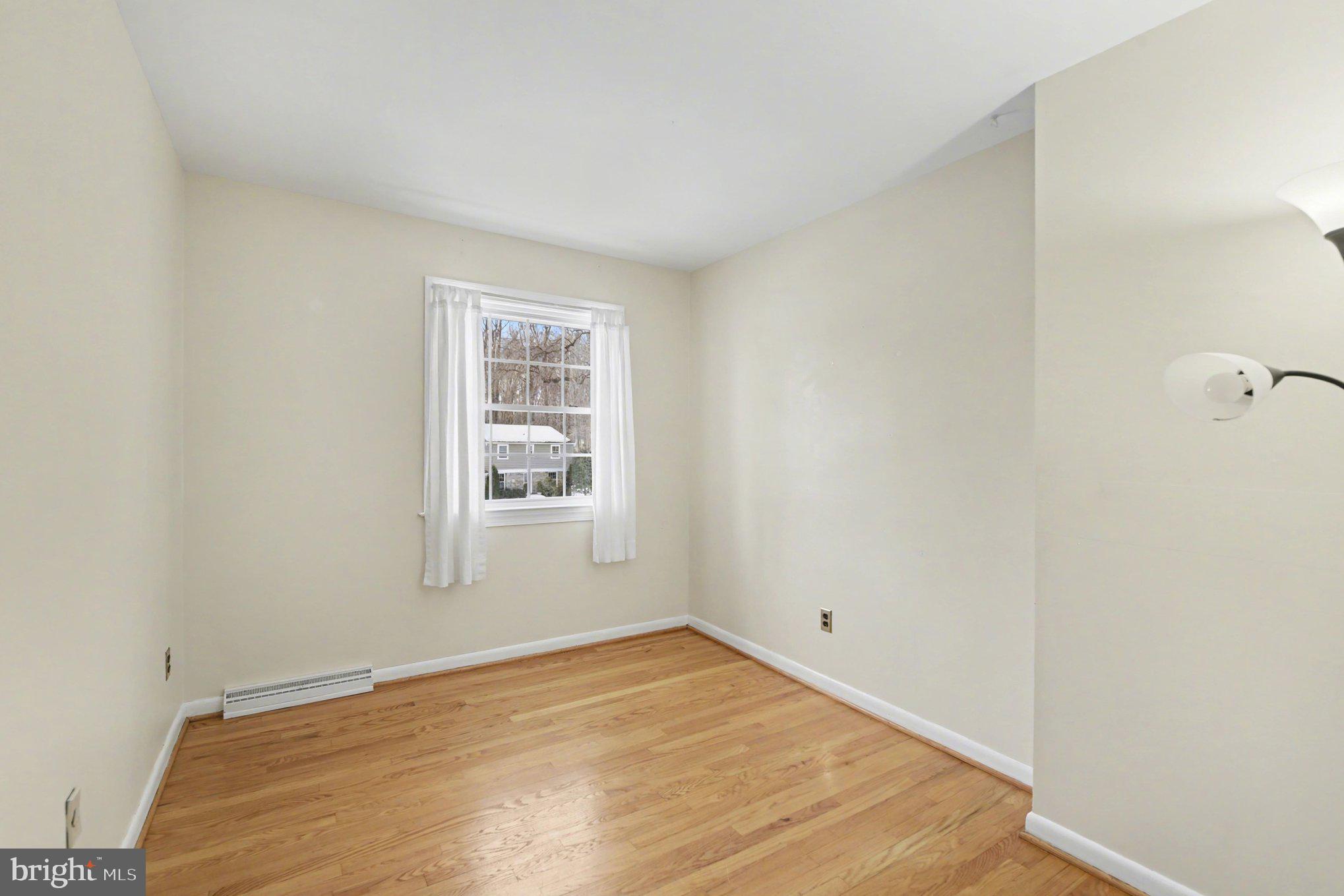 1411 Valley Stream Road Bel Air, MD 21014 - Photo 30 of 49 a view of an empty room with wooden floor and a window