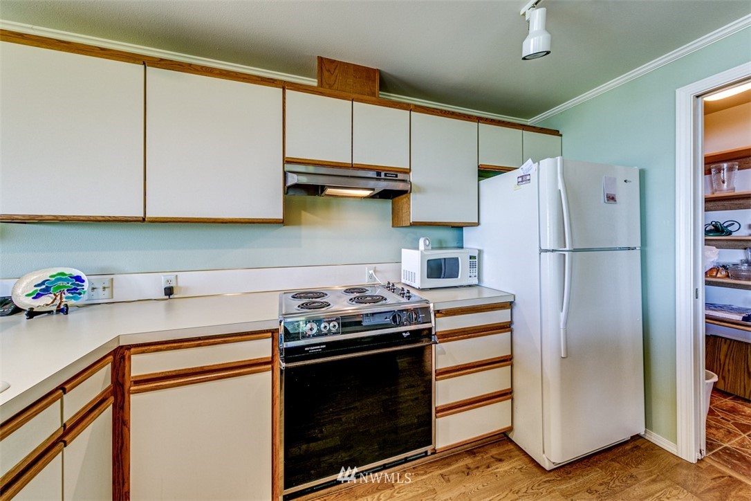 226 West 2nd Street, Unit 2 Port Angeles, WA 98362 - Photo 18 of 40 a kitchen with stainless steel appliances a stove a refrigerator and cabinets
