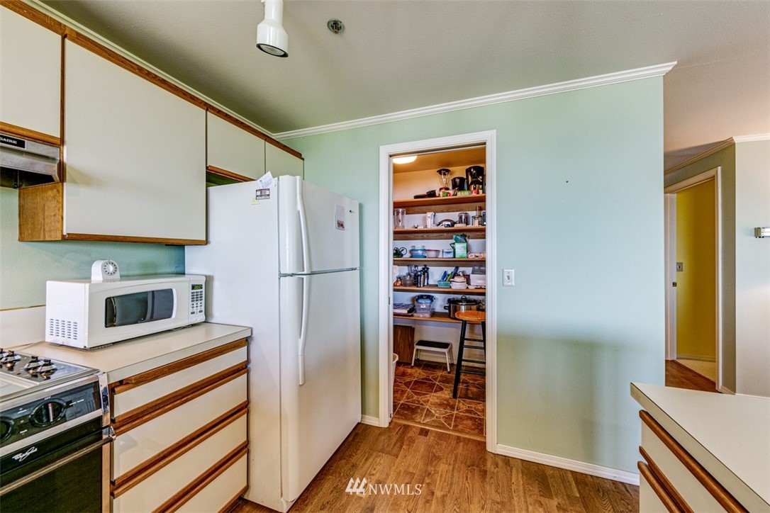 226 West 2nd Street, Unit 2 Port Angeles, WA 98362 - Photo 19 of 40 a kitchen with stainless steel appliances a refrigerator and a stove top oven