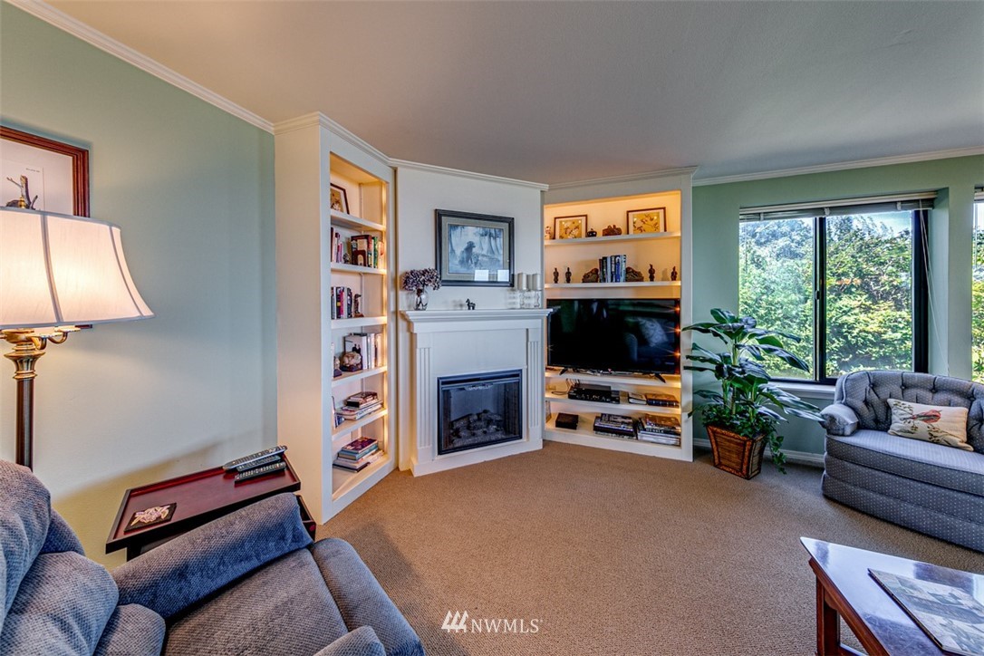 226 West 2nd Street, Unit 2 Port Angeles, WA 98362 - Photo 21 of 40 a living room with furniture a flat screen tv and a fireplace
