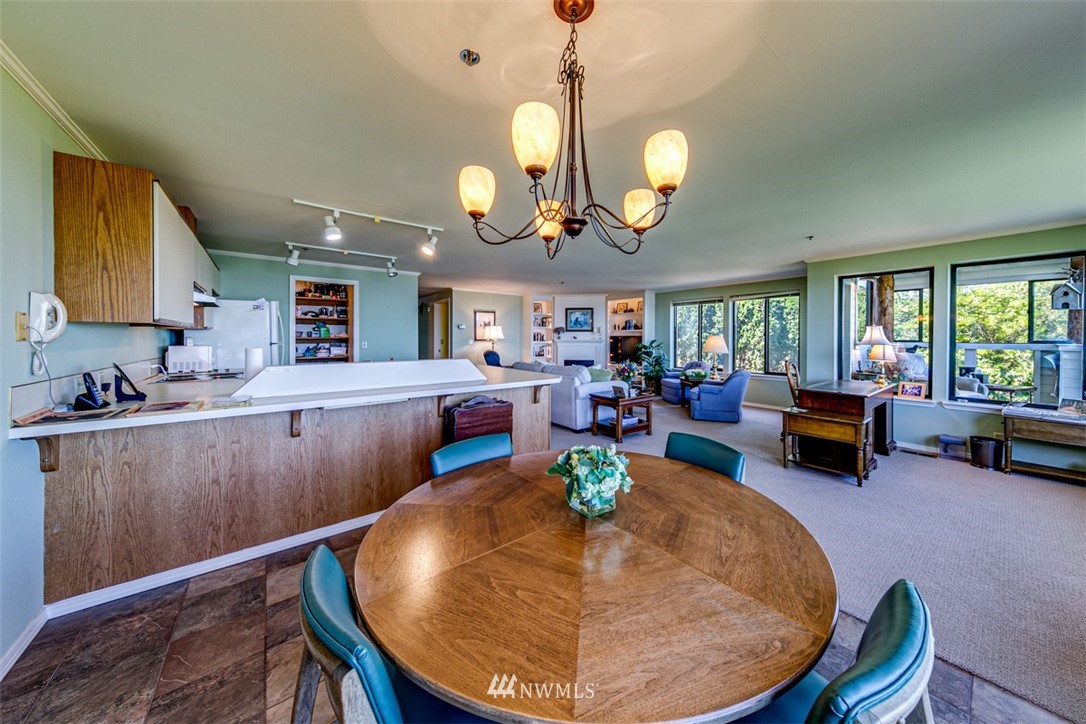 226 West 2nd Street, Unit 2 Port Angeles, WA 98362 - Photo 31 of 40 a view of a dining room and kitchen with furniture a chandelier and wooden floor