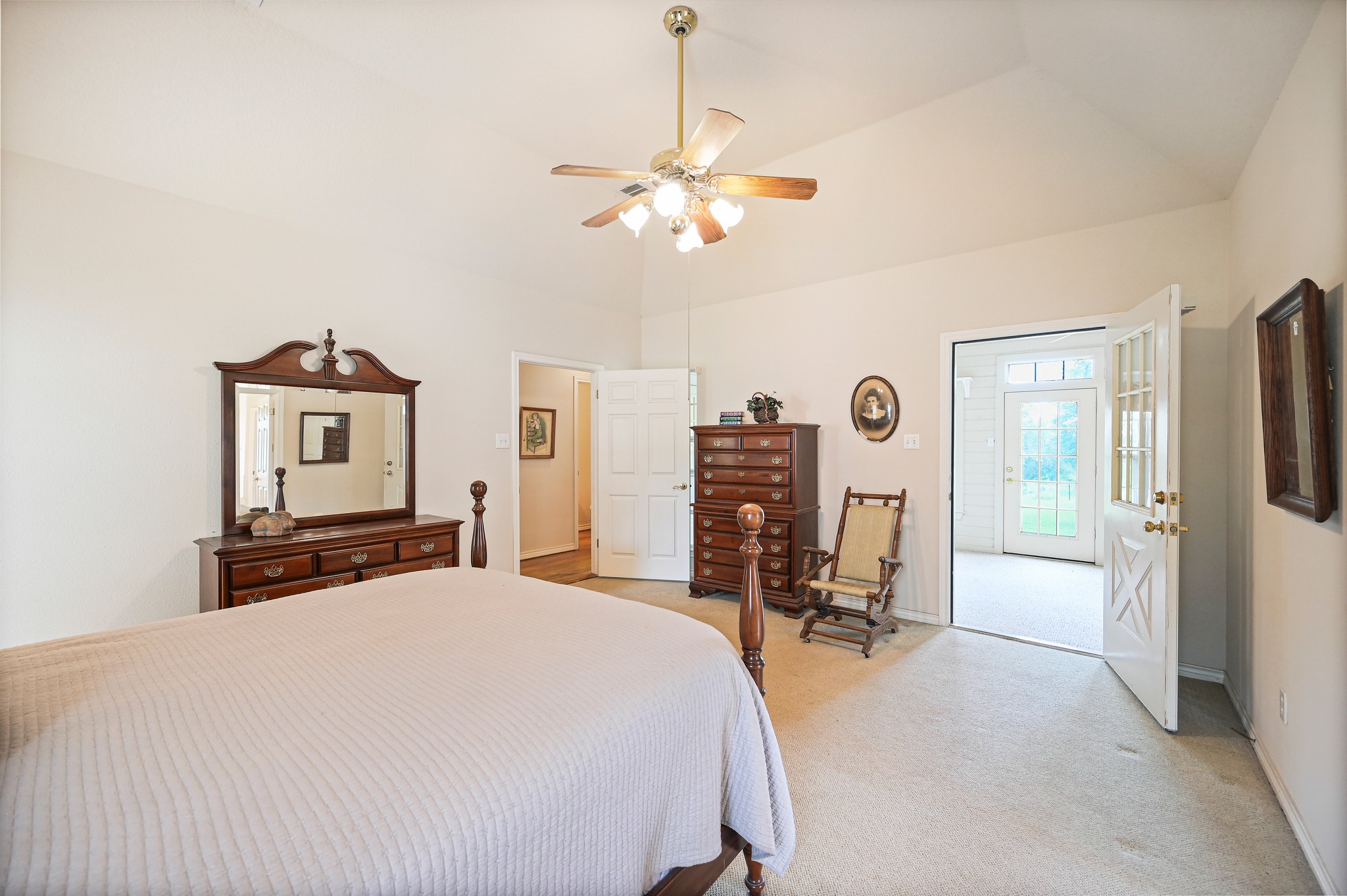 364 Nameless Road Driftwood, TX 78619 - Photo 17 of 32 A peaceful primary bedroom retreat with vaulted ceilings and outdoor access.