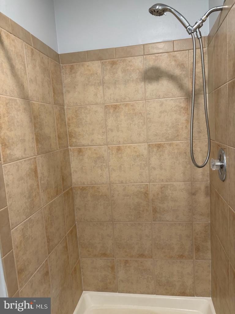 6803 Wild Rose Court Springfield, VA 22152 - Photo 19 of 49 a bathroom with a shower