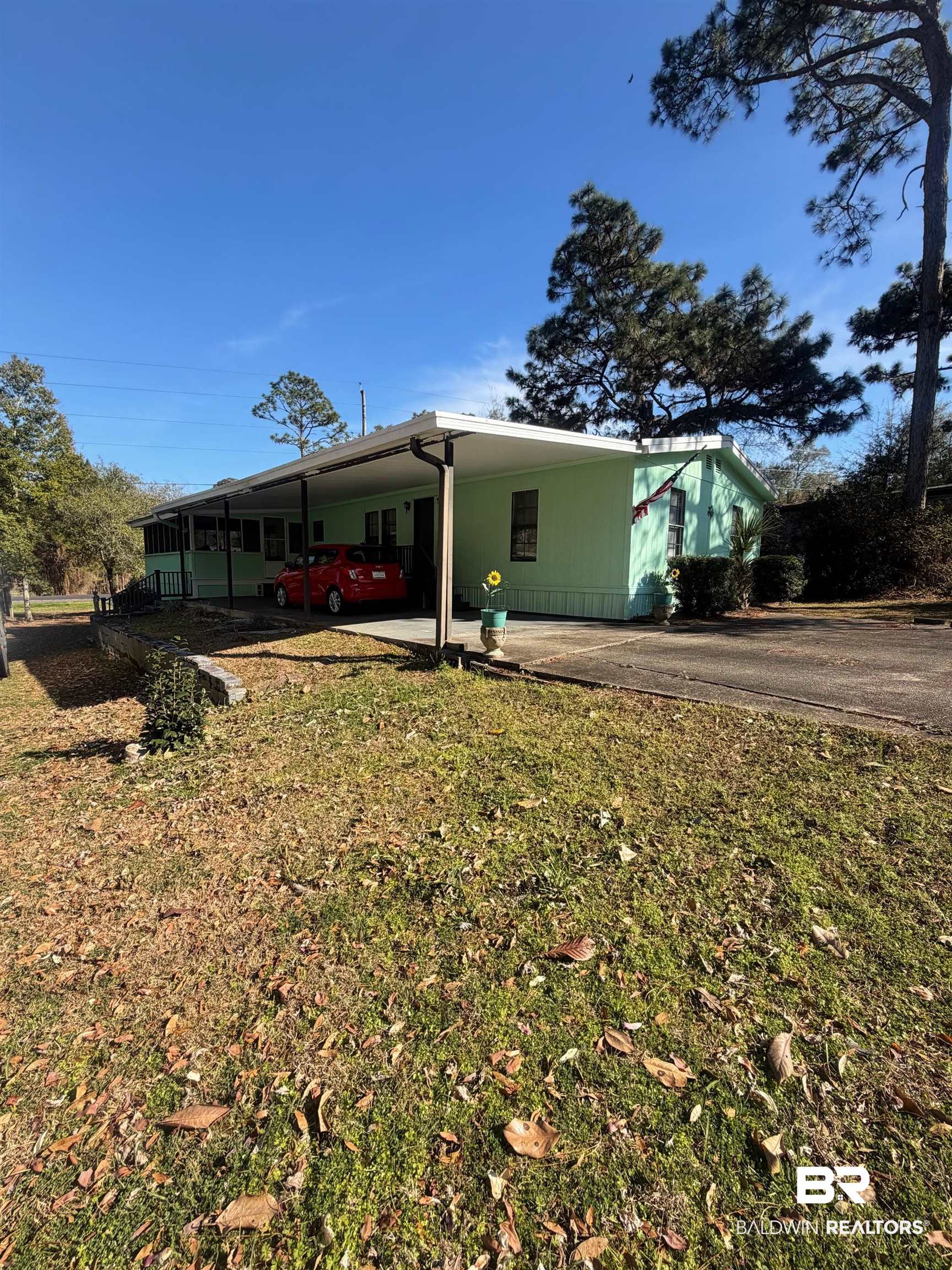 1430 Ridgewood Drive Lillian, AL 36549 - Photo 16 of 34 Back of house with a carport, a lawn, and a patio area
