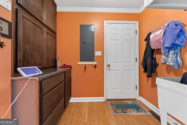 a living room with furniture kitchen area and a window