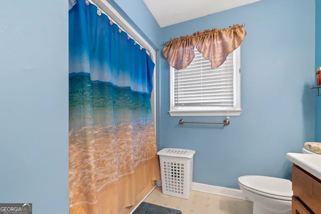 a room with furniture and a air conditioner vent