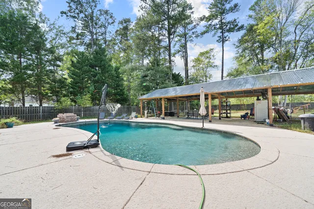 a view of a swimming pool with a table and chairs