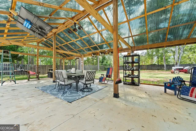 a view of a house with a small yard and a patio