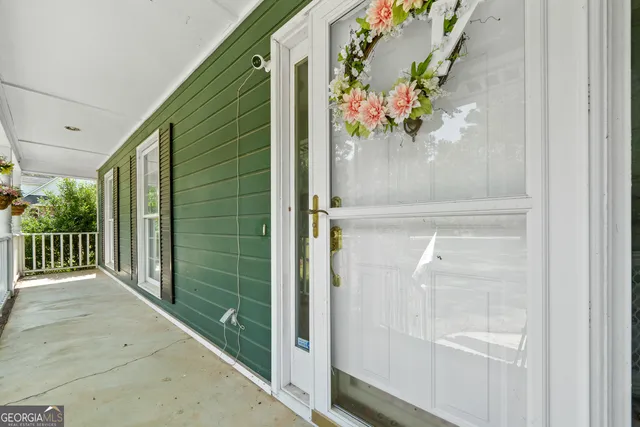 a view of entryway and gallery with wooden floor