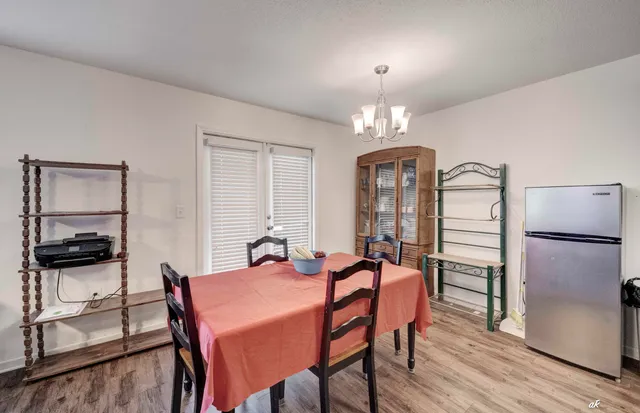 a view of a dining room with furniture and chandelier