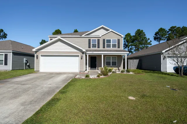 a front view of a house with garden and porch