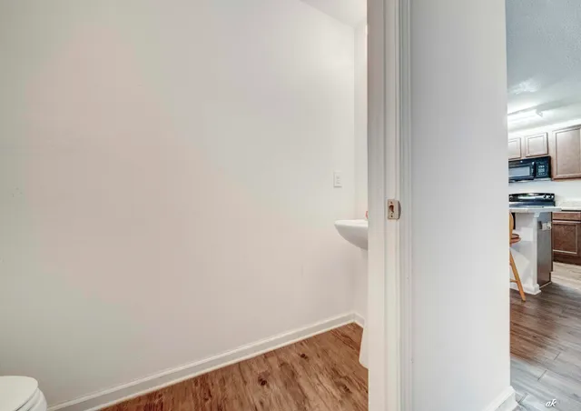 a view of a hallway with wooden floor