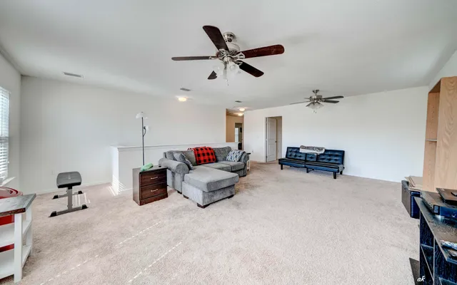 a living room with furniture and white walls