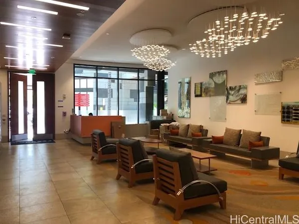 a living room with patio furniture and chandelier