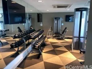a room with gym equipment and a flat screen tv
