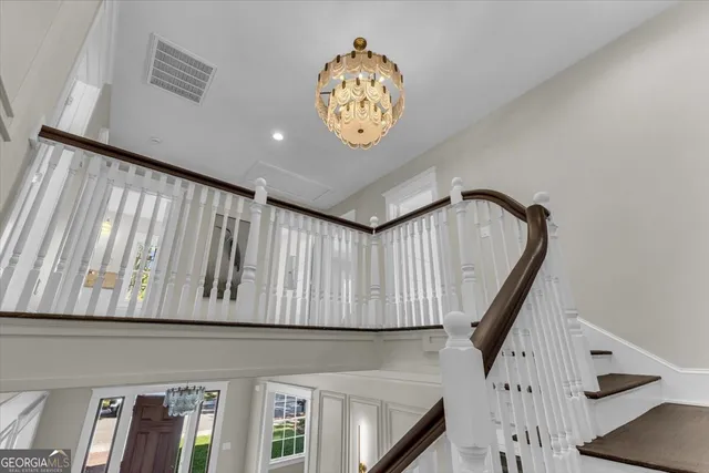 a view of an entryway with wooden floor and cabinet