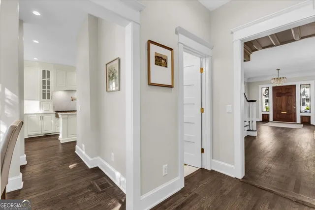 a kitchen with stainless steel appliances granite countertop a stove a sink and a wooden floor