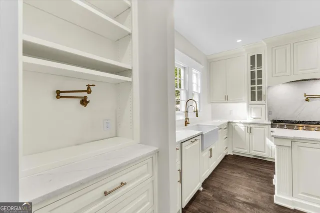 a view of an empty room with wooden floor and window