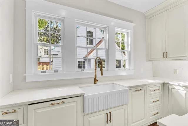 a view of a room with wooden floor and painting on the wall