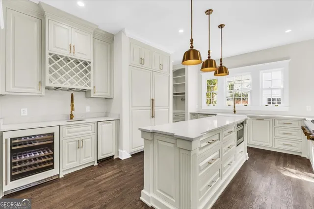 a spacious bedroom with a large bed a chandelier and a window