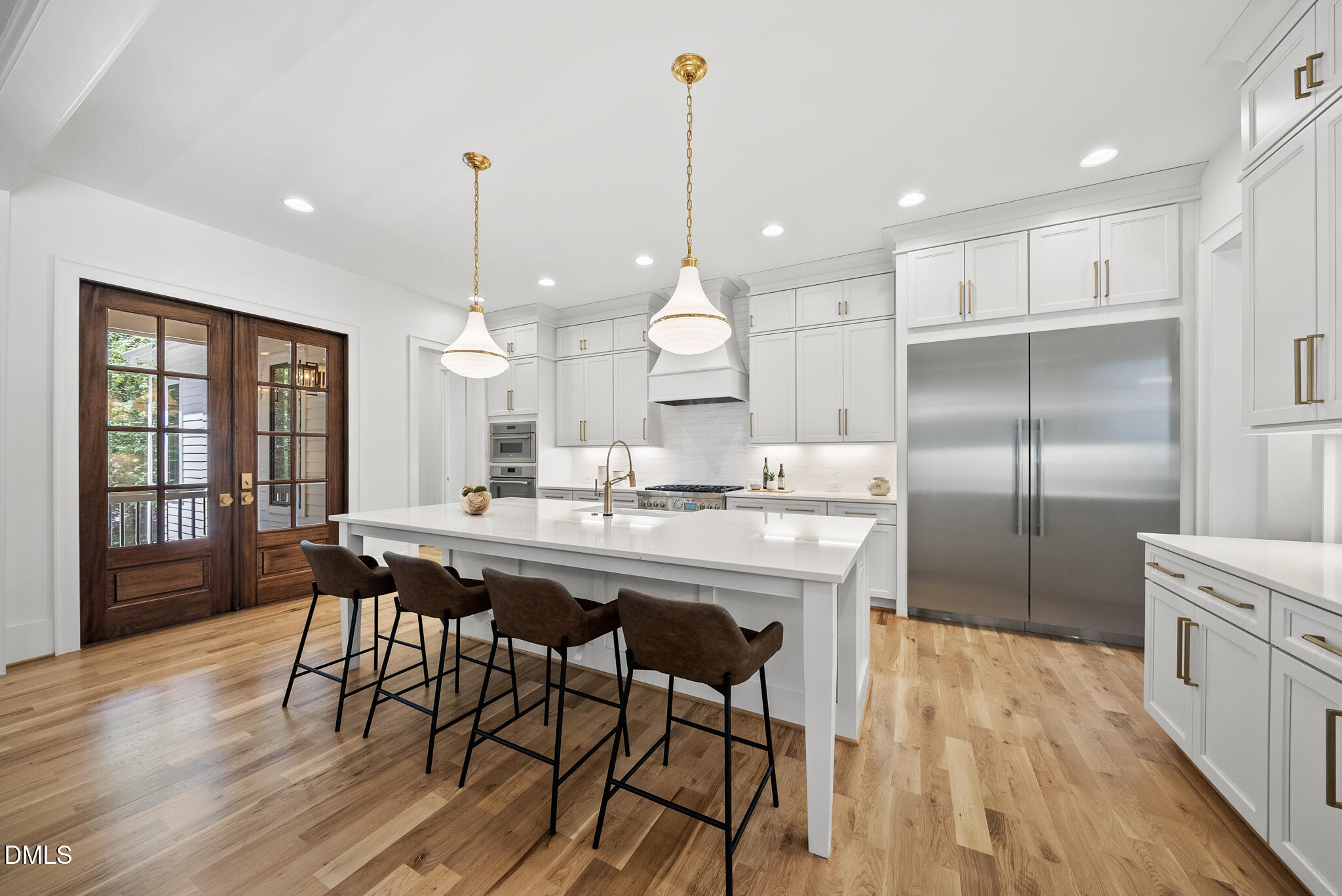 1609 Ridge Road Raleigh, NC 27607 - Photo 11 of 62 a kitchen with stainless steel appliances kitchen island granite countertop a dining table chairs and wooden floor