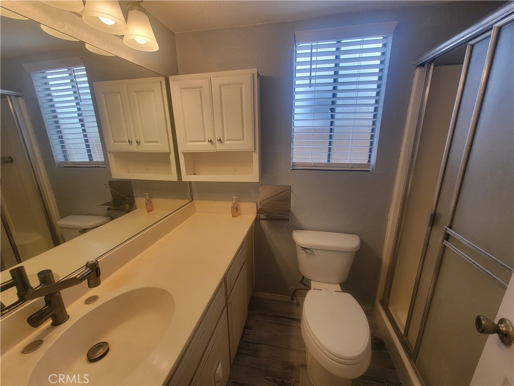 15005 Indiana Paramount, CA 90723 - Photo 6 of 7 a bathroom with a sink a toilet and a mirror