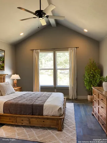 a bedroom with a bed and a potted plant