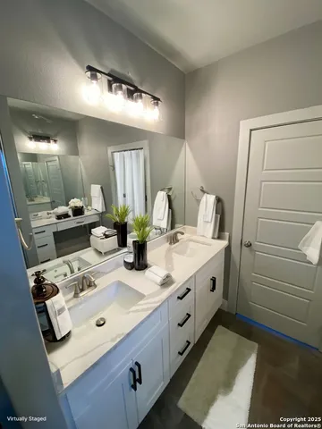 a bathroom with a granite countertop sink and a mirror